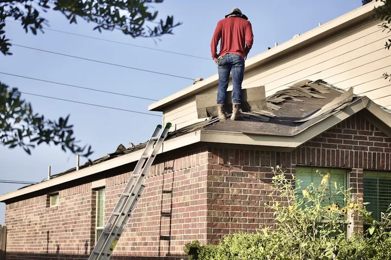 Professional roofer working on a residential roof in Palms